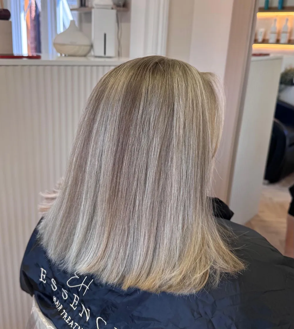 Shoulder-length blonde cut with a clean, blunt finish