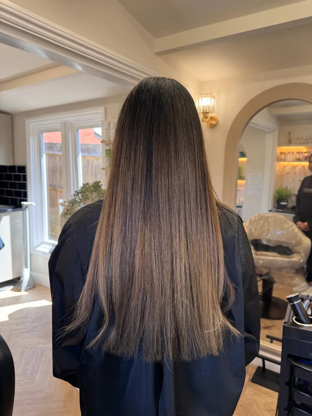 Long, smooth brunette hair with subtle highlights after Hair Botox