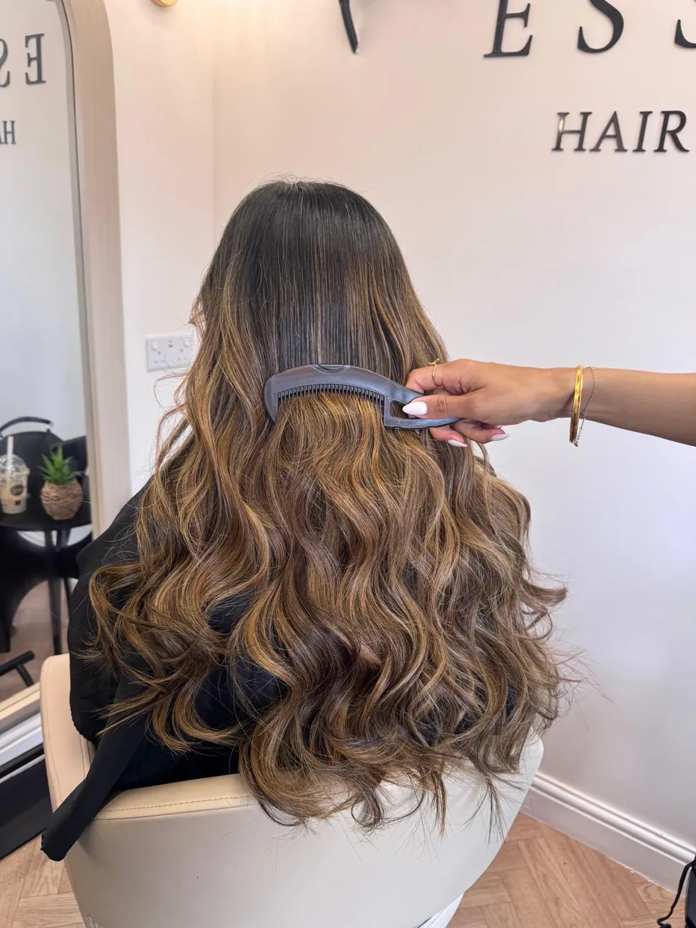 Long brunette hair with caramel balayage and soft curls
