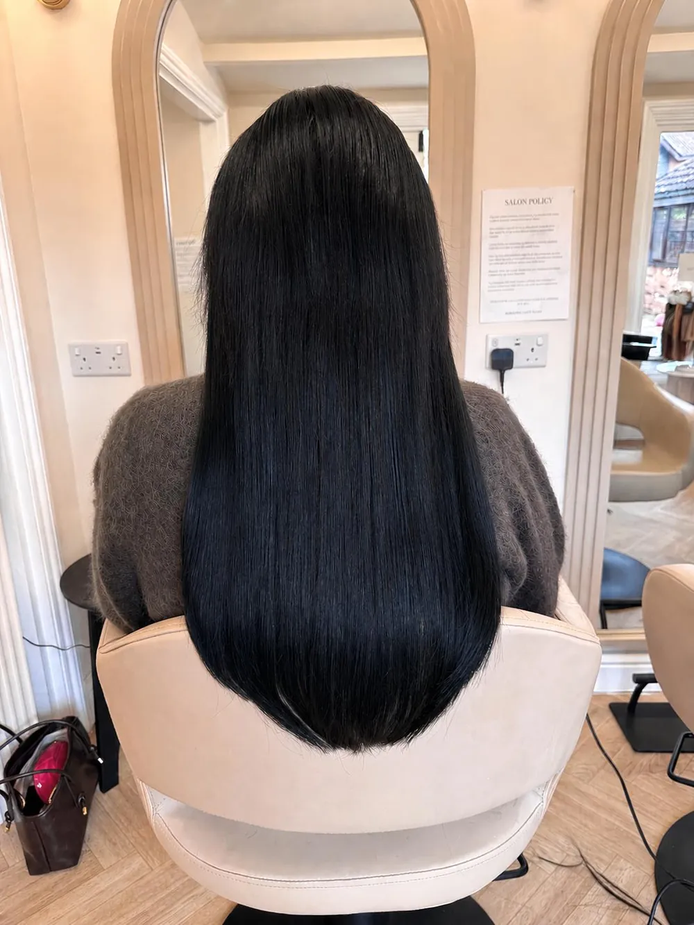 Long, sleek, glossy black hair after a treatment at Essence