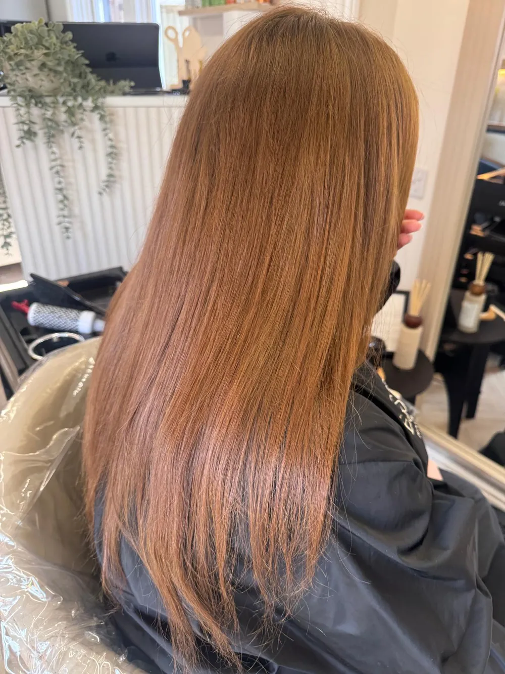 Long, glossy copper hair after a Hair Botox treatment