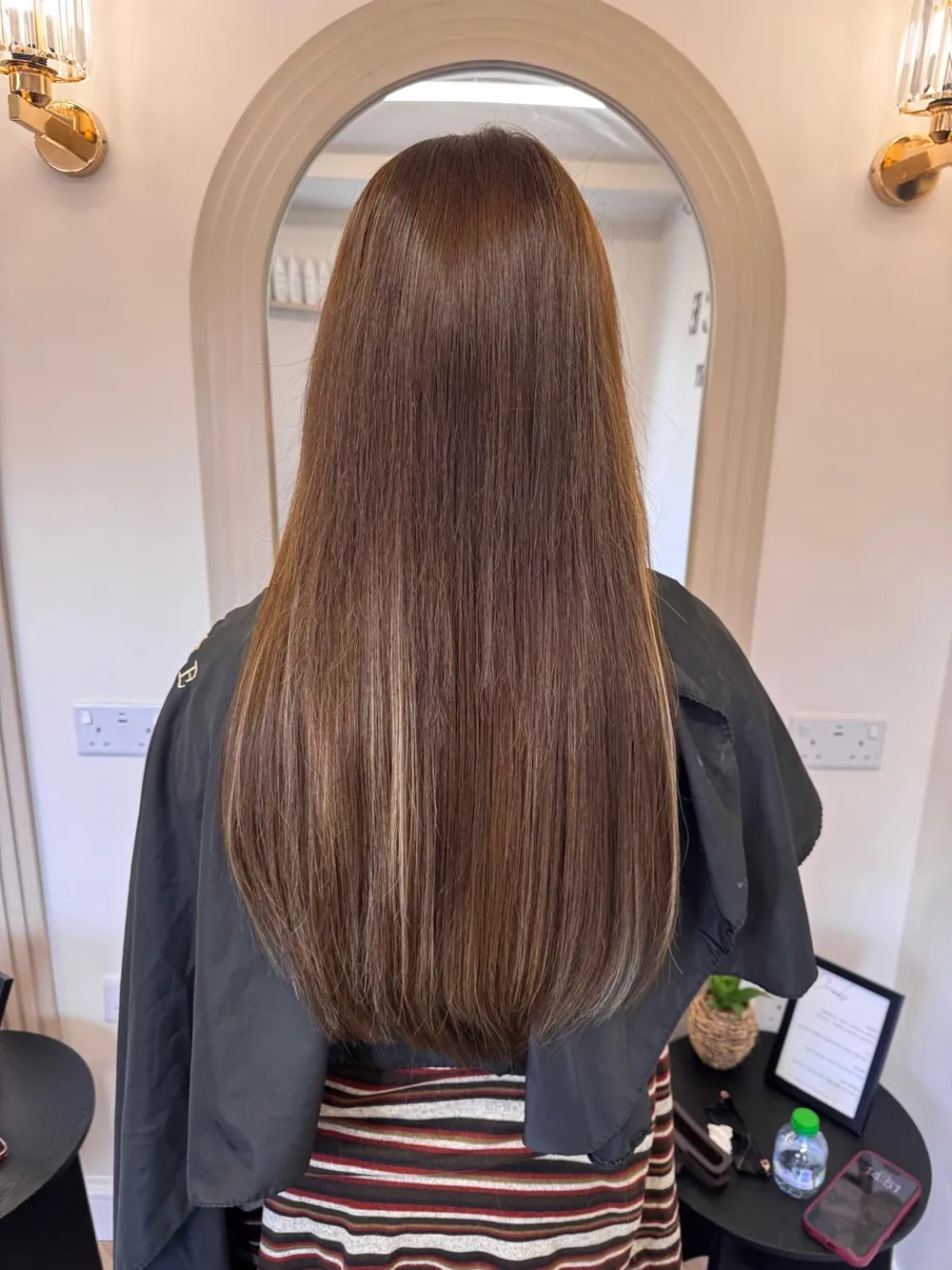 Long, sleek chocolate-brown hair with subtle highlights after a Keratin treatment