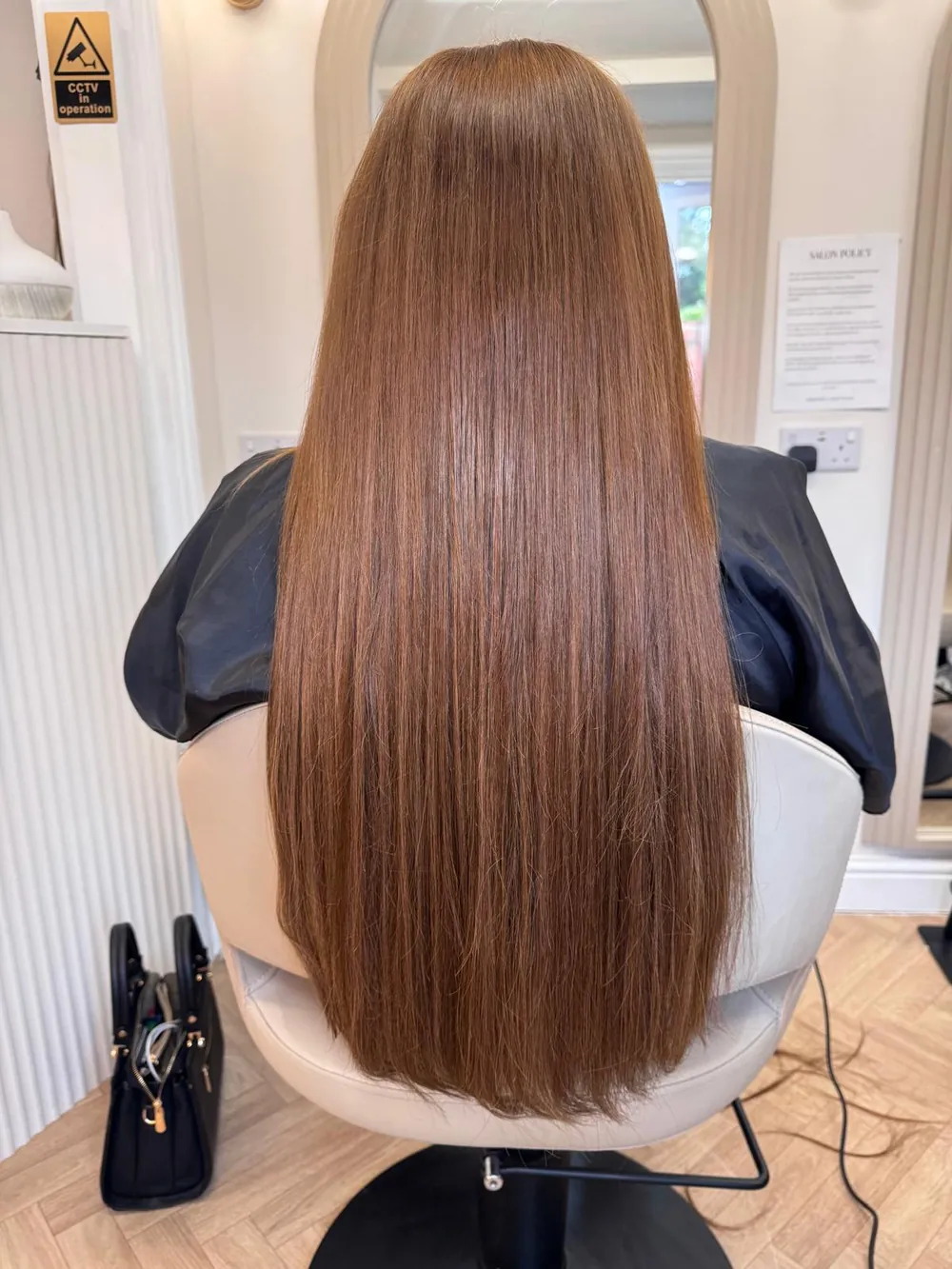 Long, straight, glossy chestnut-brown hair, back view, Essence salon in Luton