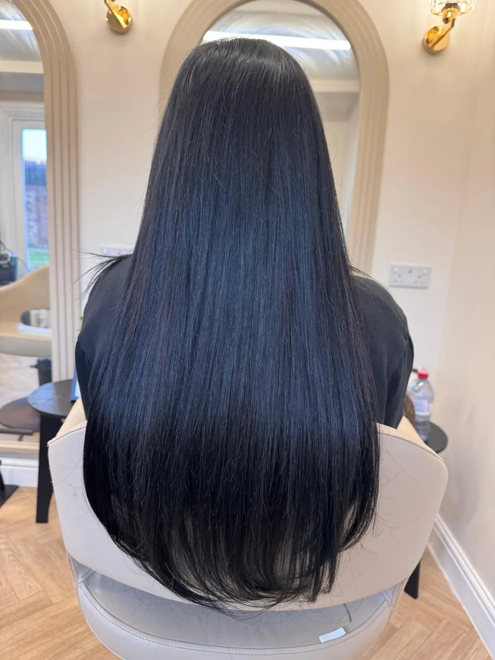 Long, sleek jet-black hair after a Keratin smoothing treatment